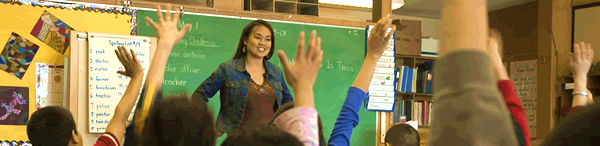Photo of a teacher directing a student's attention to instruction